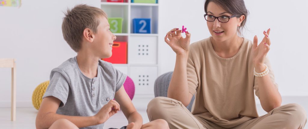 Psychotherapist talking a child.