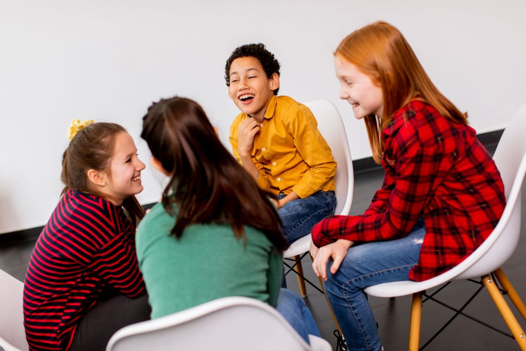 A group of kids talking and laughing.