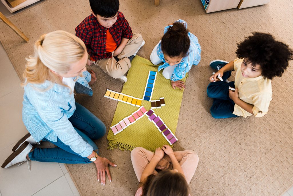 A therapist teaching kids with different levels of autism.
