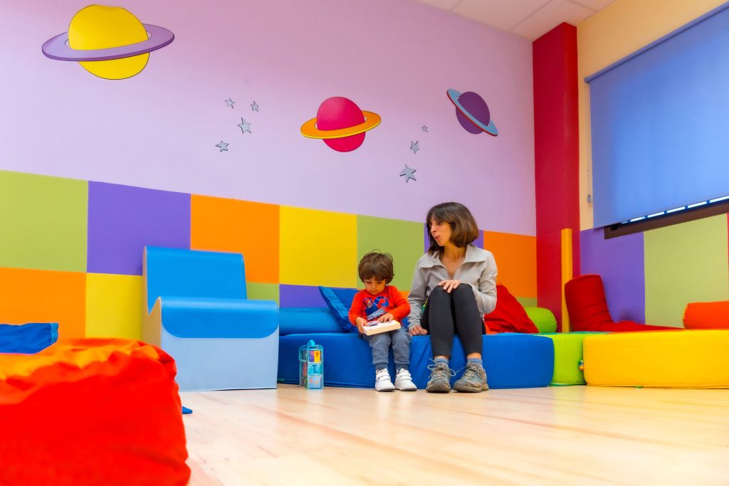A mother and her child in a colorful room.