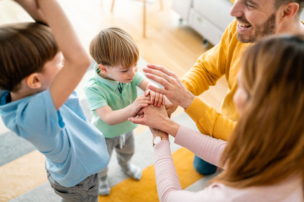 Happy family playing at the living room.