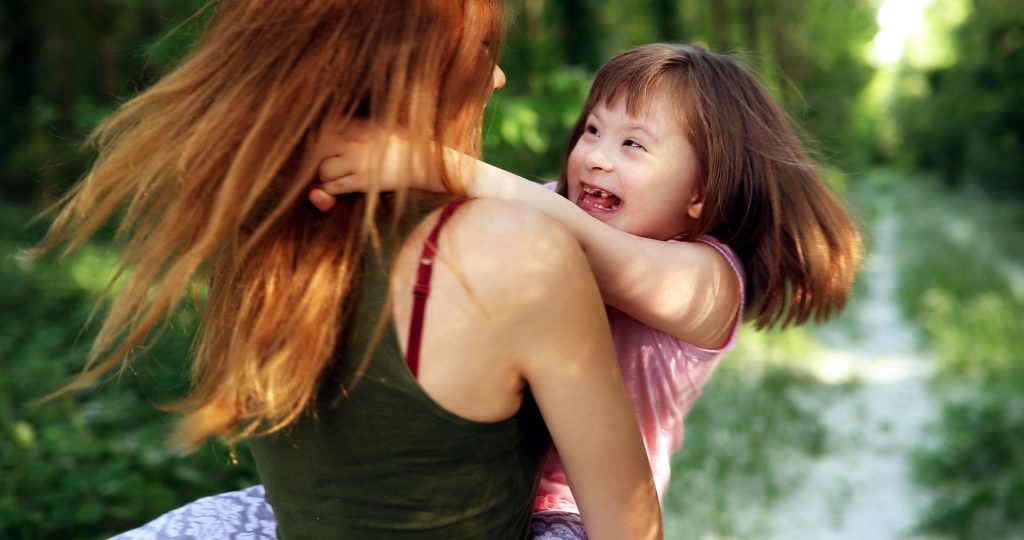 Little girl with special needs enjoying outdoors.