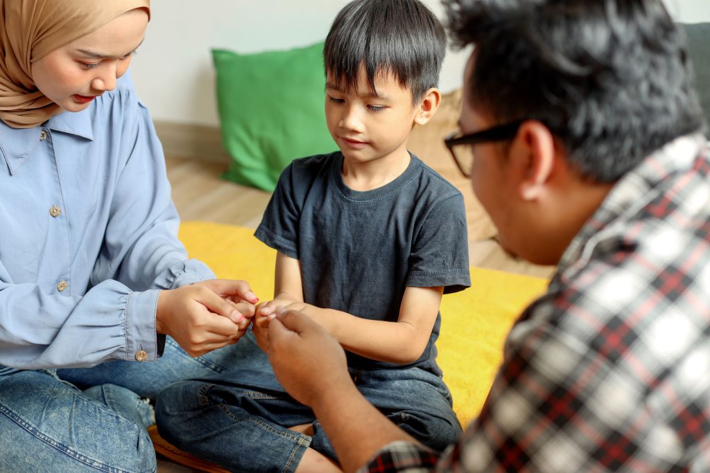 Little boy having fun with his parents.