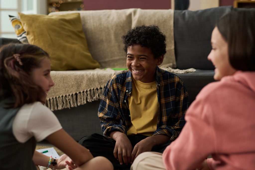 Smiling children with great social skills indoors.