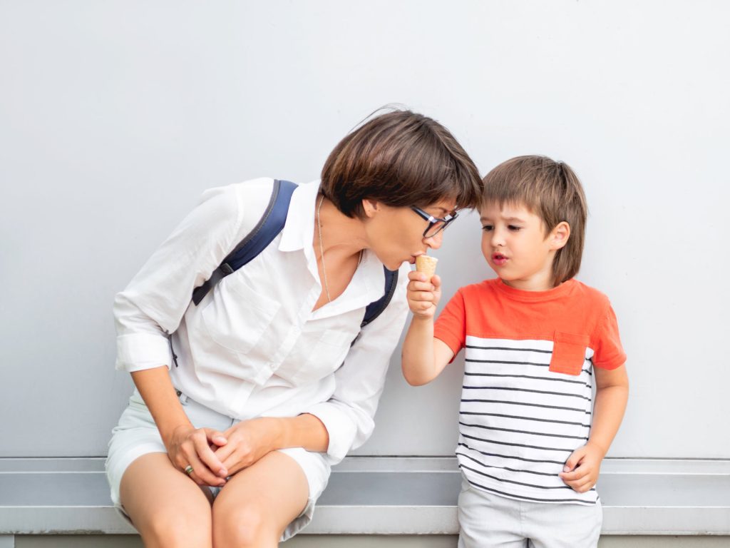 Little boy shares his ice cream.