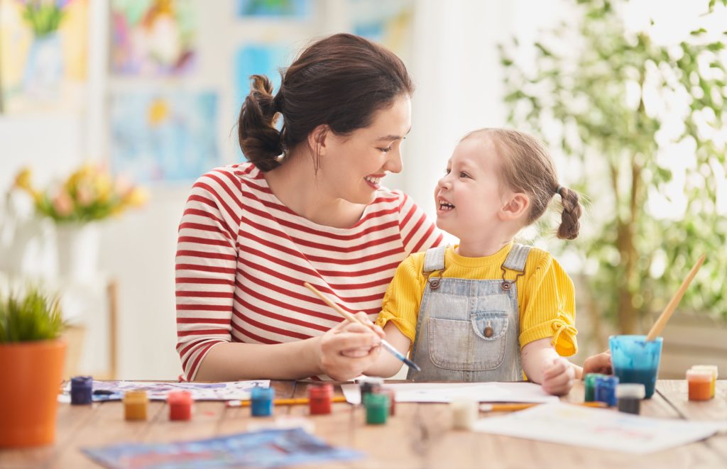 Little child and mother playing.