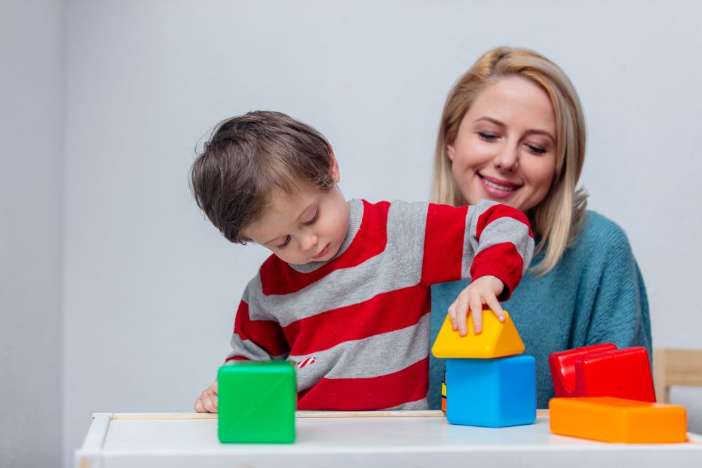 Son playing with colorful shapes.