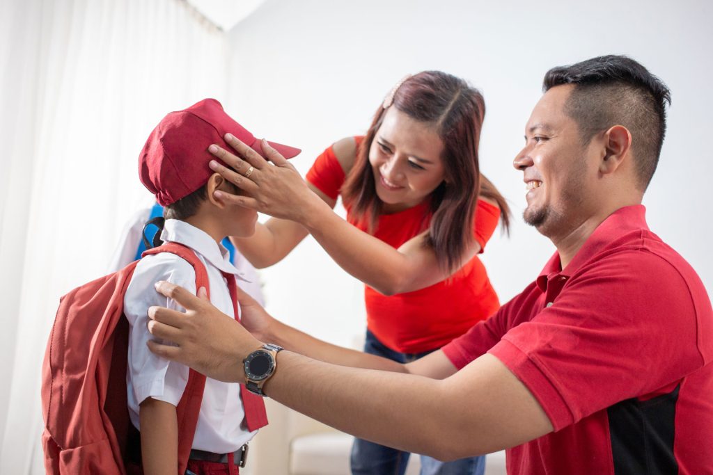 Parents help their children getting ready for school.