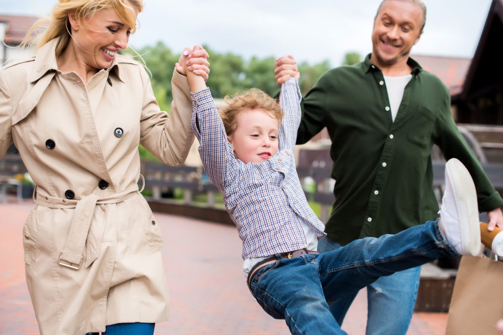 Smiling family outdoors.