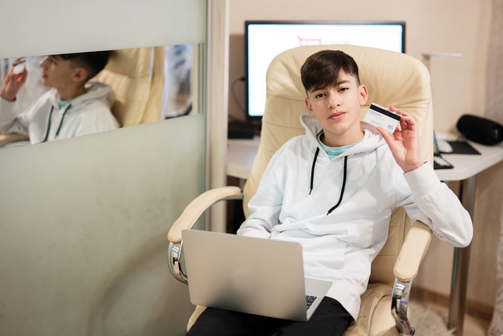 Teenage boy using a laptop.