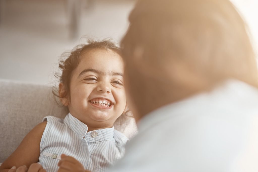 Smiling child with curly hair.